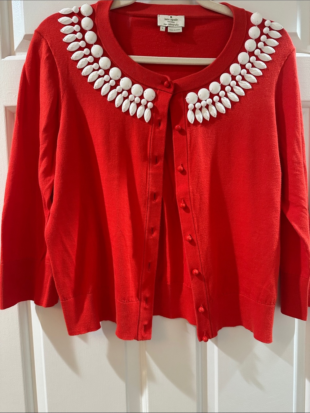 kate spade “kati” orange cardigan with white jeweled collar